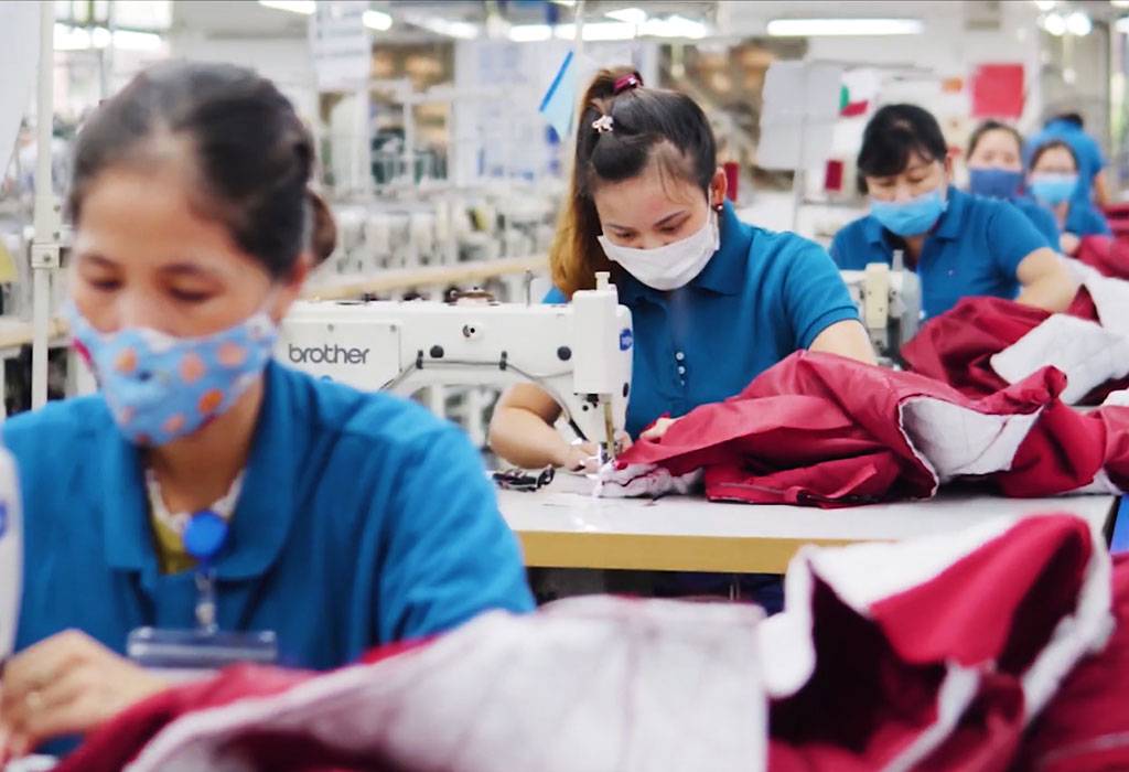 A group of women sewing on a sewing machine