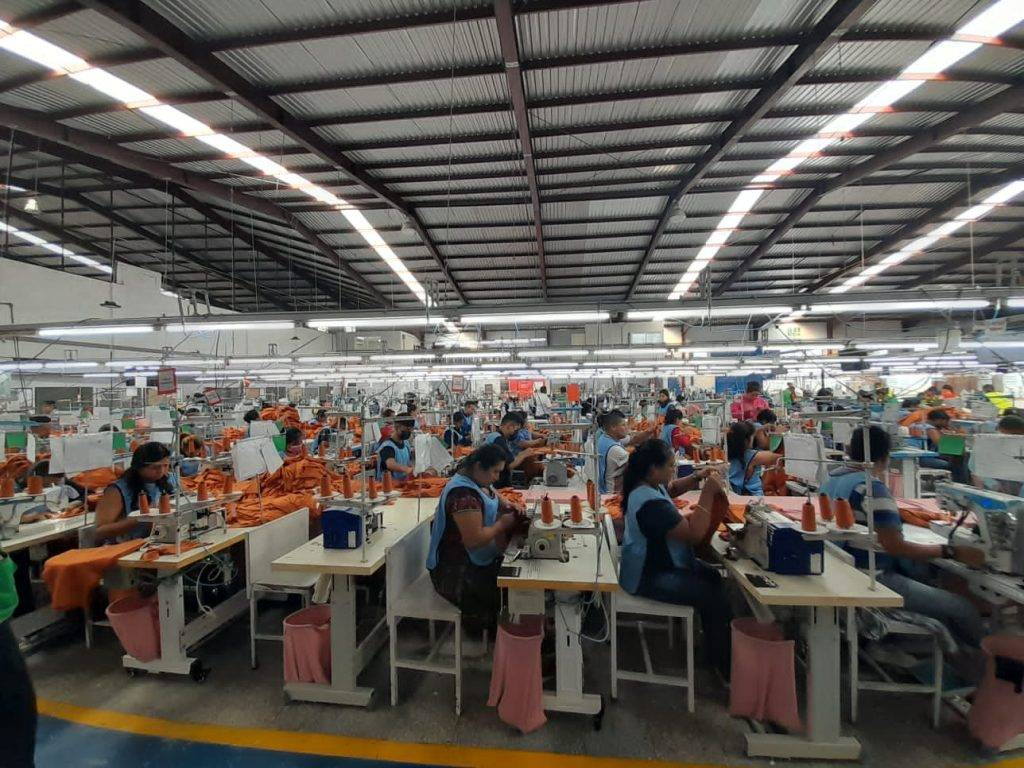 A group of women sewing on a sewing machine