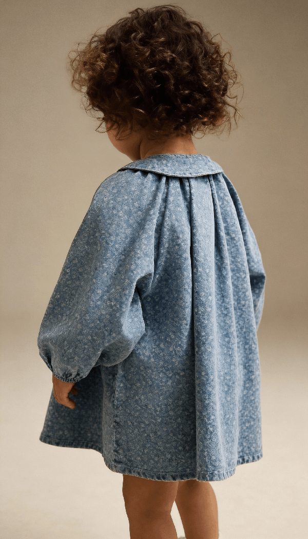 Child wearing a children’s wear dress showcasing kids apparel design and fit