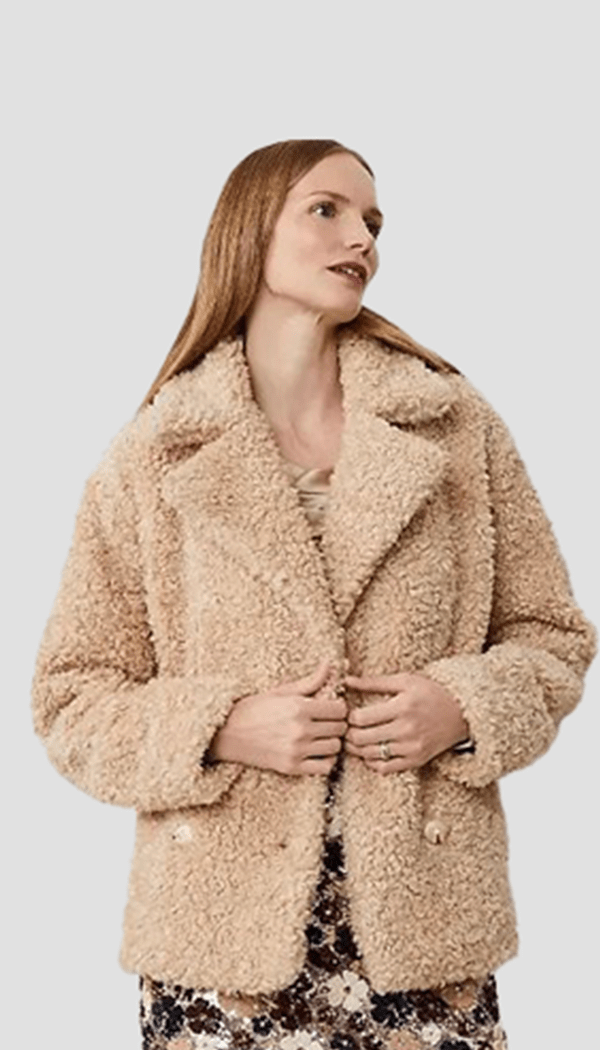 Model wearing a textured outerwear jacket showcasing outerwear apparel design and fit