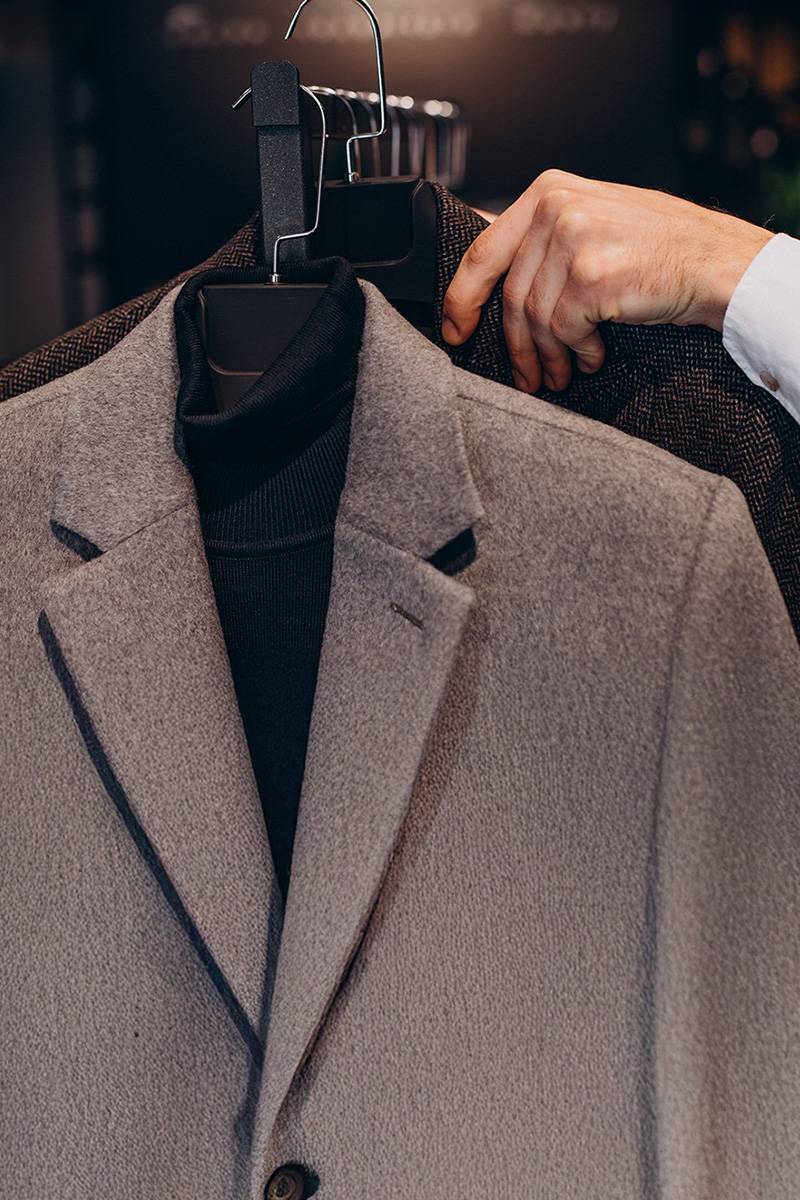 Woven formal jackets on hangers showcasing apparel manufacturing quality